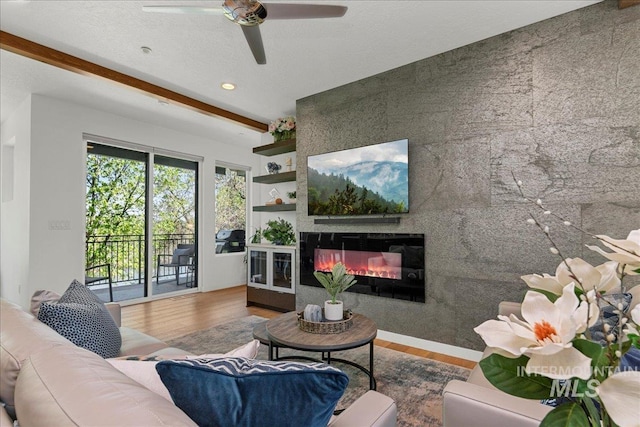 3602 N Prospect Way, Garden City, ID 83714 - living area featuring wood finished floors, a glass covered fireplace, ceiling fan, beam ceiling, and recessed lighting