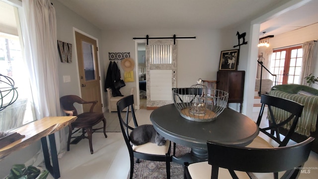 dining room featuring french doors and a barn door