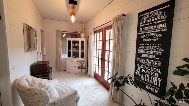 sitting room featuring carpet and french doors