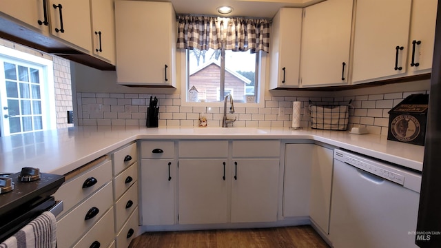 kitchen with wood finished floors, white cabinetry, a sink, light countertops, and dishwasher