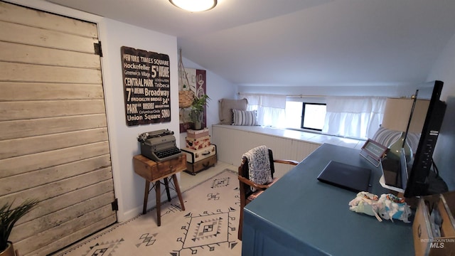 carpeted office featuring lofted ceiling