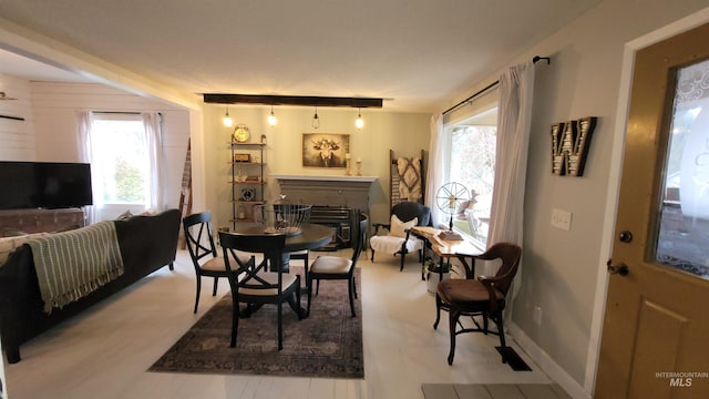 dining area with baseboards and a fireplace