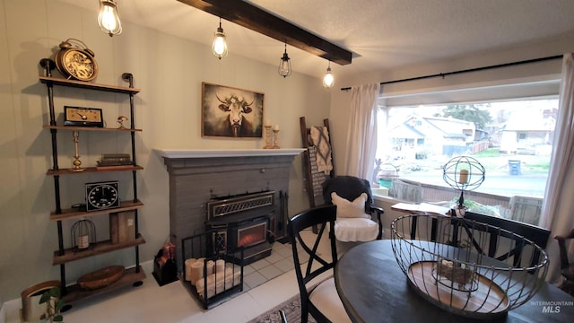 interior space featuring beam ceiling and a wood stove