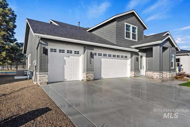 view of front of home featuring central AC unit and a garage