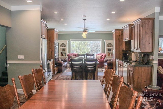 dining space with sink and ceiling fan