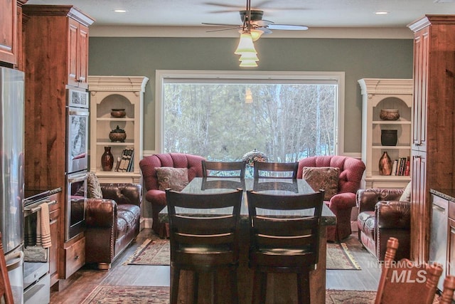 dining space with plenty of natural light, dark wood-type flooring, and ceiling fan