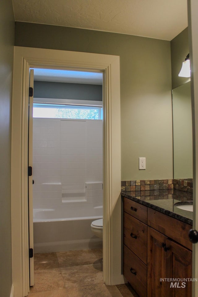 full bathroom with vanity, bathtub / shower combination, and toilet