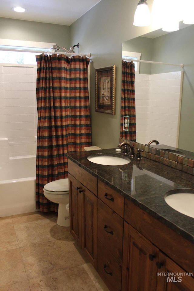 full bathroom with shower / tub combo, vanity, tile patterned flooring, and toilet