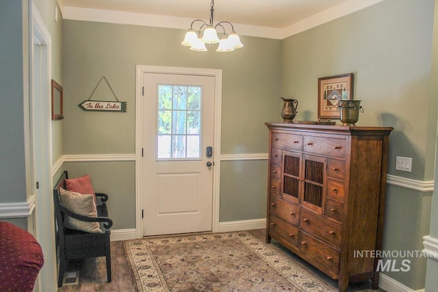 entryway with wood-type flooring and a chandelier