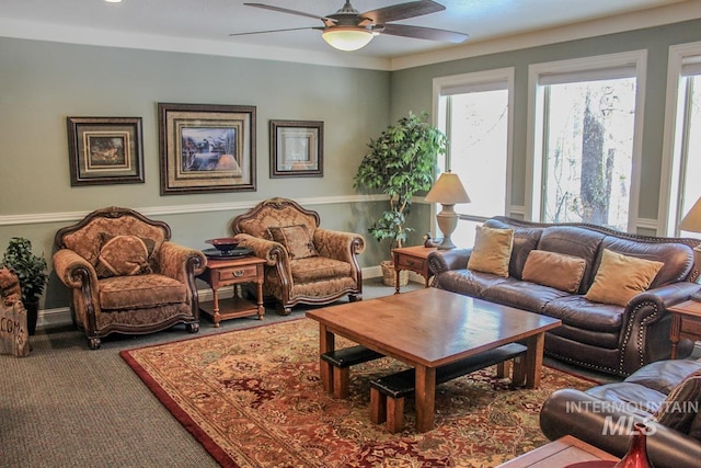 carpeted living room with ceiling fan