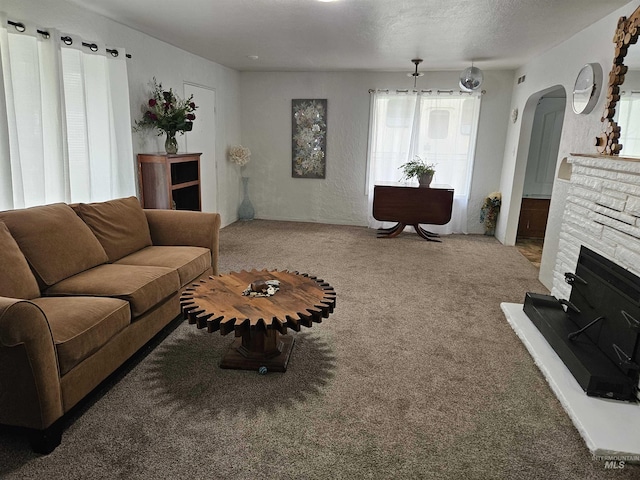 207 N Main St, Homedale, ID 83628 - carpeted living area with arched walkways and a stone fireplace