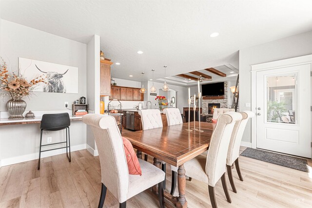 1670 Mary Hill Ave, Middleton, ID 83644 - dining space with light wood finished floors, a fireplace, recessed lighting, and baseboards