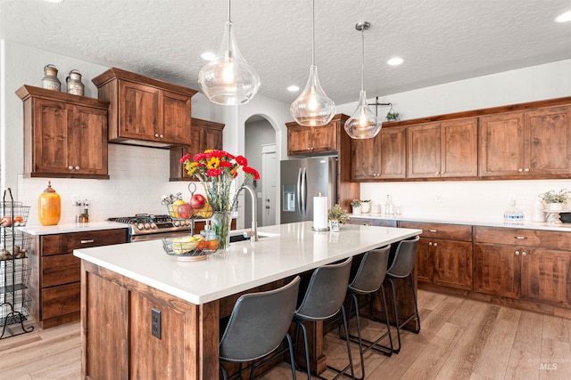 1670 Mary Hill Ave, Middleton, ID 83644 - kitchen with stainless steel appliances, light wood-style floors, an island with sink, light countertops, and recessed lighting