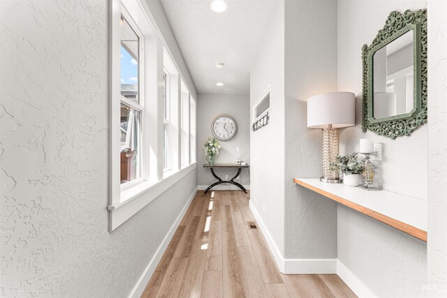 1670 Mary Hill Ave, Middleton, ID 83644 - hall with light wood-type flooring, a textured wall, recessed lighting, and baseboards
