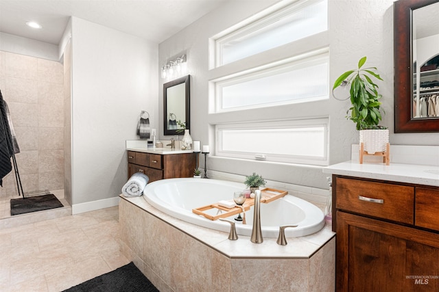 1670 Mary Hill Ave, Middleton, ID 83644 - bathroom featuring a bath, tiled shower, tile patterned flooring, vanity, and recessed lighting