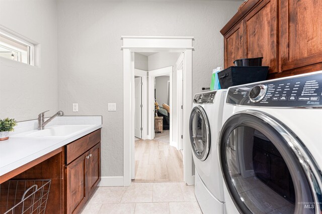 1670 Mary Hill Ave, Middleton, ID 83644 - washroom featuring cabinet space, independent washer and dryer, light tile patterned floors, and baseboards