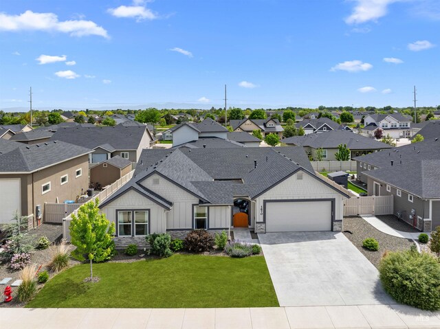 1670 Mary Hill Ave, Middleton, ID 83644 - view of front facade with stone siding, a residential view, board and batten siding, and an attached garage