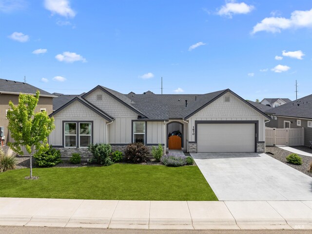 1670 Mary Hill Ave, Middleton, ID 83644 - view of front of home featuring a garage, board and batten siding, stone siding, concrete driveway, and a shingled roof