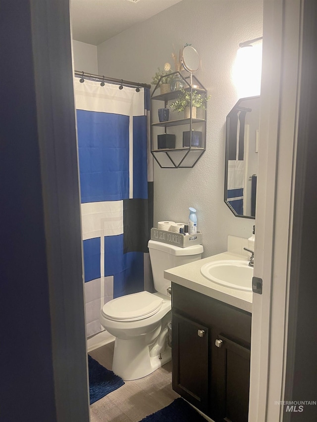 bathroom with tile patterned floors, vanity, and toilet