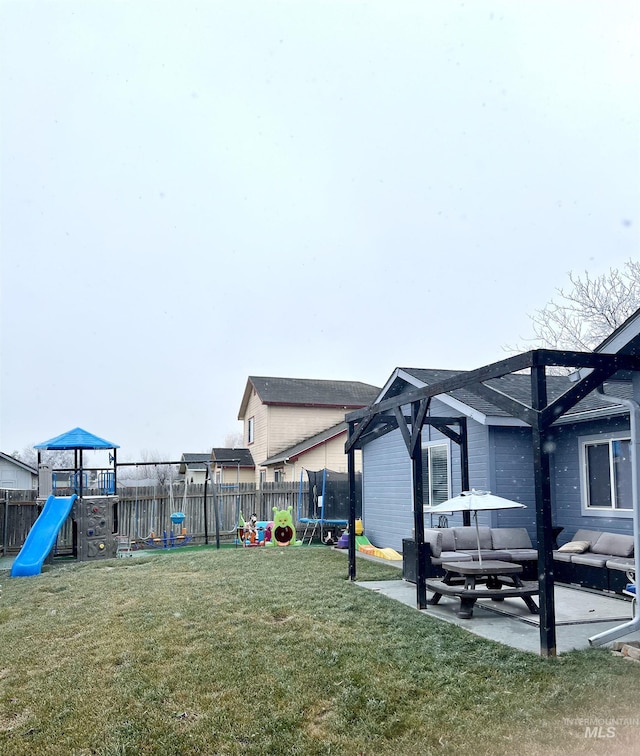 view of yard featuring a playground, a trampoline, and a patio