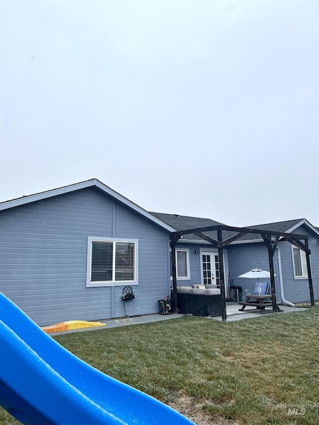 view of property exterior with a lawn, outdoor lounge area, and a patio