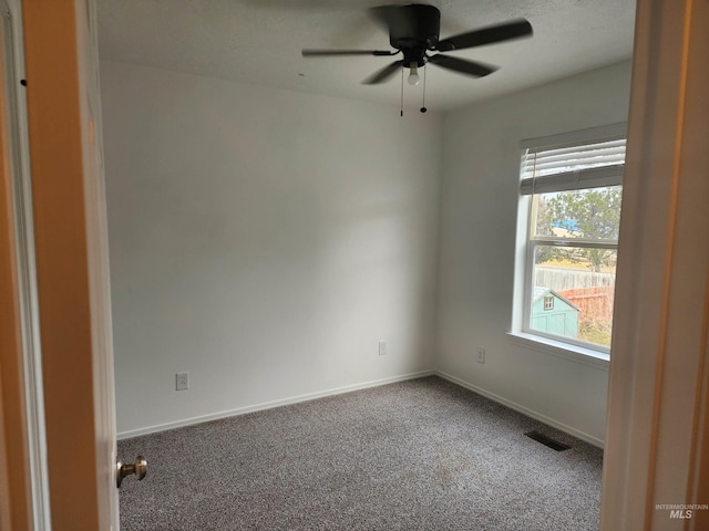 carpeted empty room featuring ceiling fan