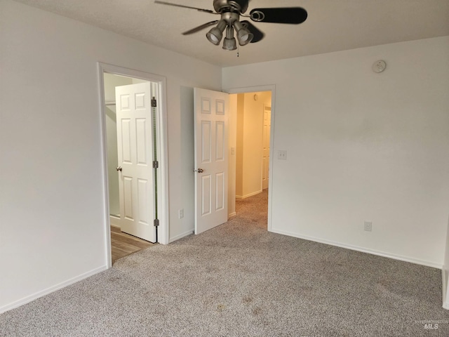 unfurnished bedroom with ceiling fan and carpet