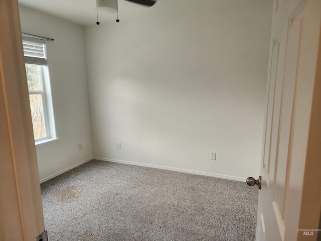 spare room featuring carpet floors, a healthy amount of sunlight, and ceiling fan