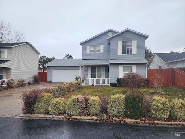 view of property featuring a garage and a porch