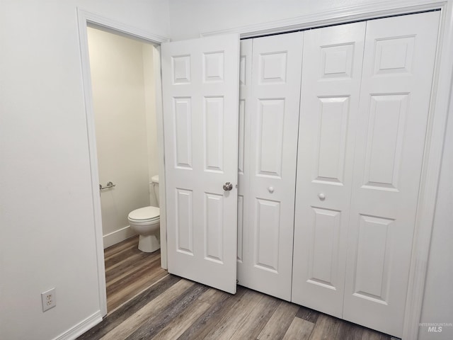 bathroom with wood-type flooring and toilet