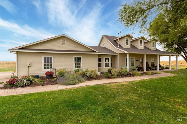 view of front of house with a patio area and a front lawn