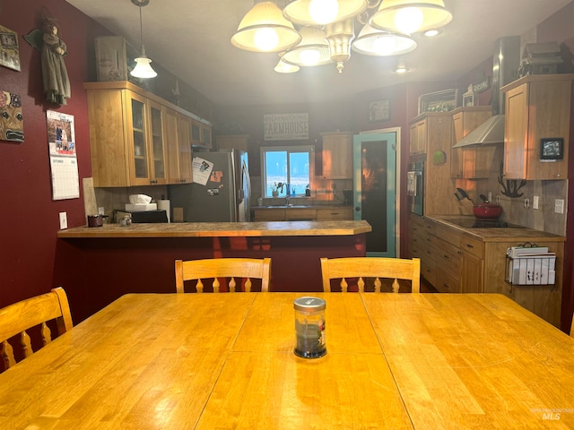 dining room featuring a notable chandelier and sink