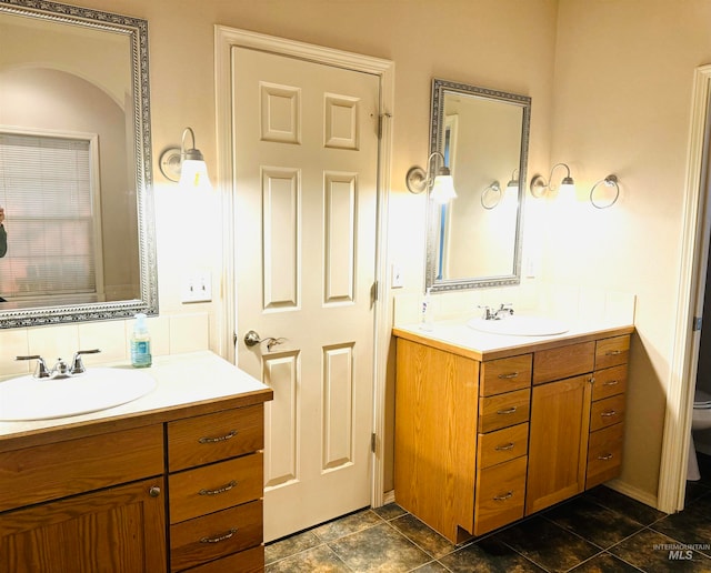 bathroom featuring vanity and toilet