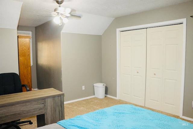 carpeted bedroom with a closet, lofted ceiling, and ceiling fan