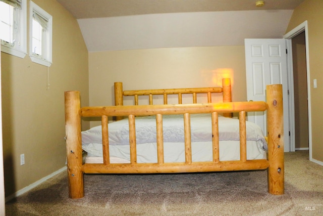 carpeted bedroom with lofted ceiling