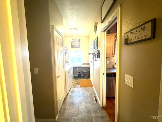 hall with a textured ceiling