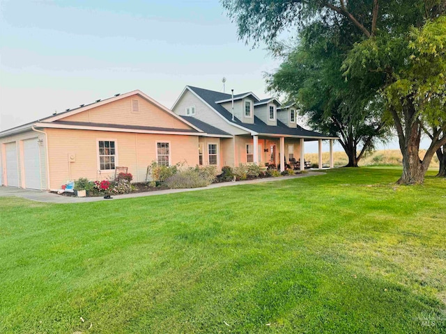 view of front of property with a front yard and a garage