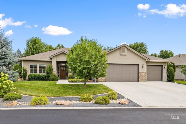 ranch-style house featuring a garage and a front lawn