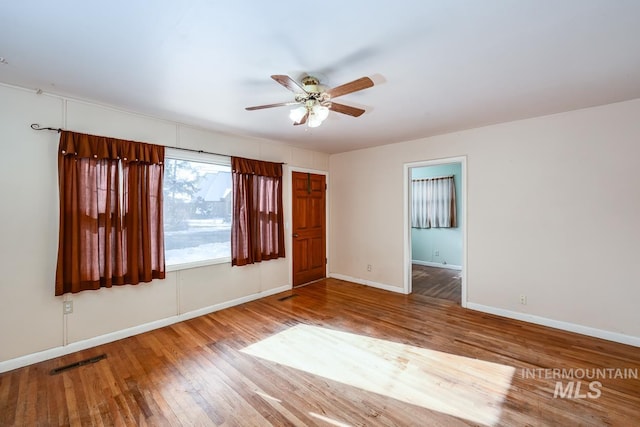 spare room with ceiling fan and wood-type flooring