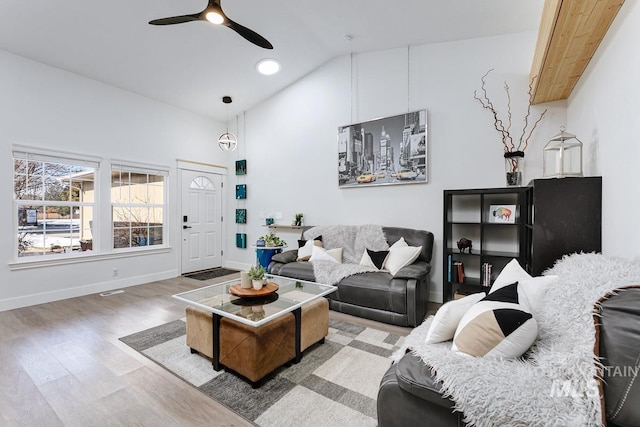 8079 W Beckton Ln, Garden City, ID 83714 - living room with a ceiling fan, wood finished floors, baseboards, and high vaulted ceiling