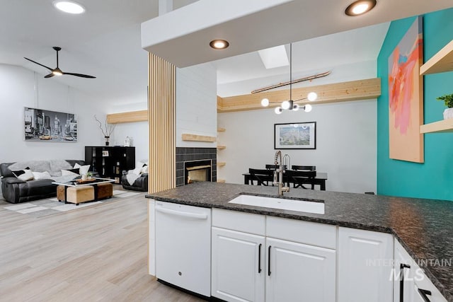 8079 W Beckton Ln, Garden City, ID 83714 - kitchen featuring white dishwasher, a sink, white cabinetry, a fireplace, and light wood finished floors