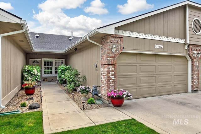 8079 W Beckton Ln, Garden City, ID 83714 - property entrance with roof with shingles, brick siding, and an attached garage