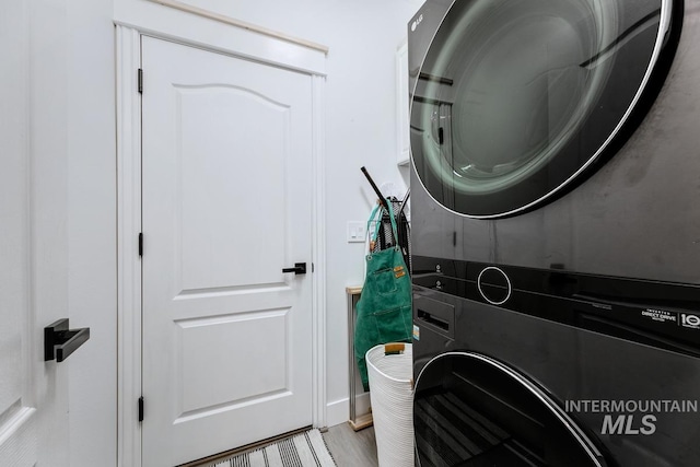8079 W Beckton Ln, Garden City, ID 83714 - laundry area with stacked washing machine and dryer and light wood finished floors