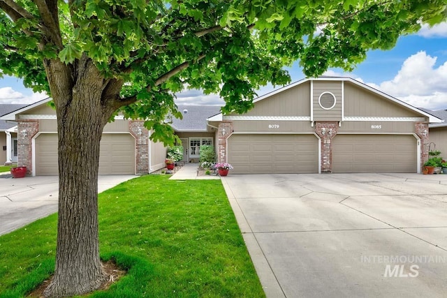 8079 W Beckton Ln, Garden City, ID 83714 - view of front of house with brick siding, concrete driveway, a garage, and a front yard