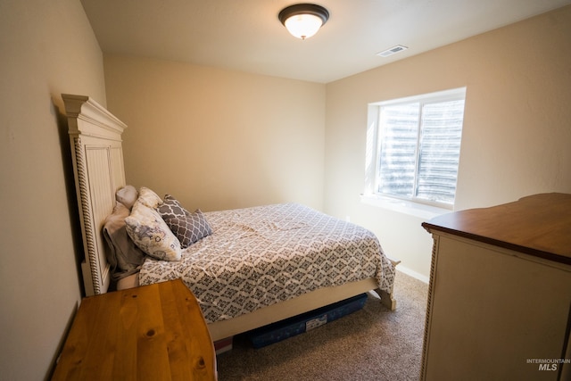 carpeted bedroom featuring visible vents and baseboards