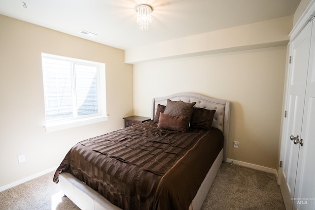 carpeted bedroom featuring baseboards and visible vents