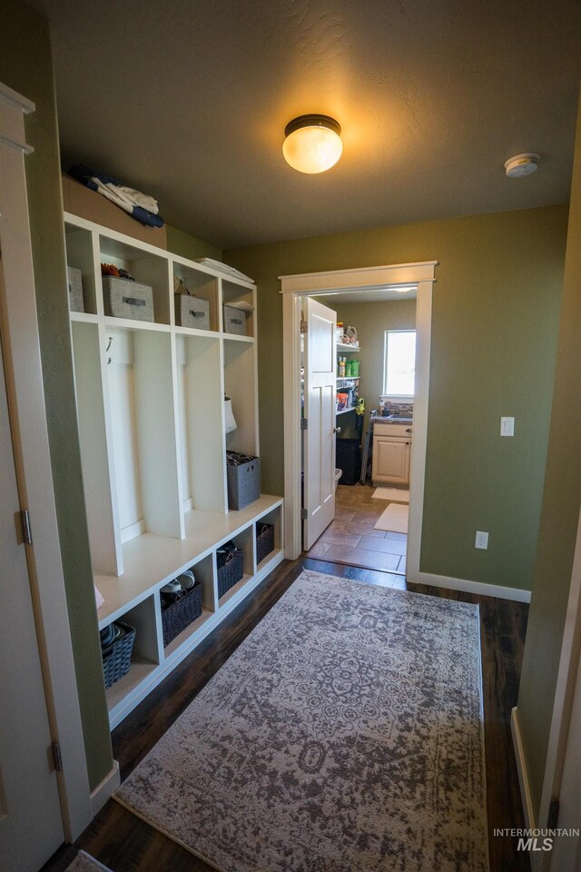 mudroom with wood finished floors and baseboards