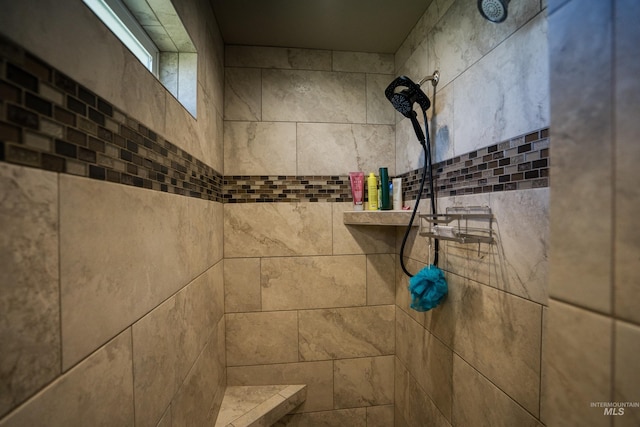 interior details featuring tiled shower