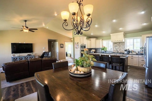 dining space with recessed lighting, vaulted ceiling, dark wood-style floors, and ceiling fan with notable chandelier