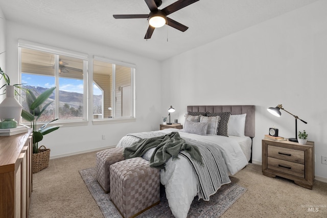 bedroom with a ceiling fan, carpet, and baseboards